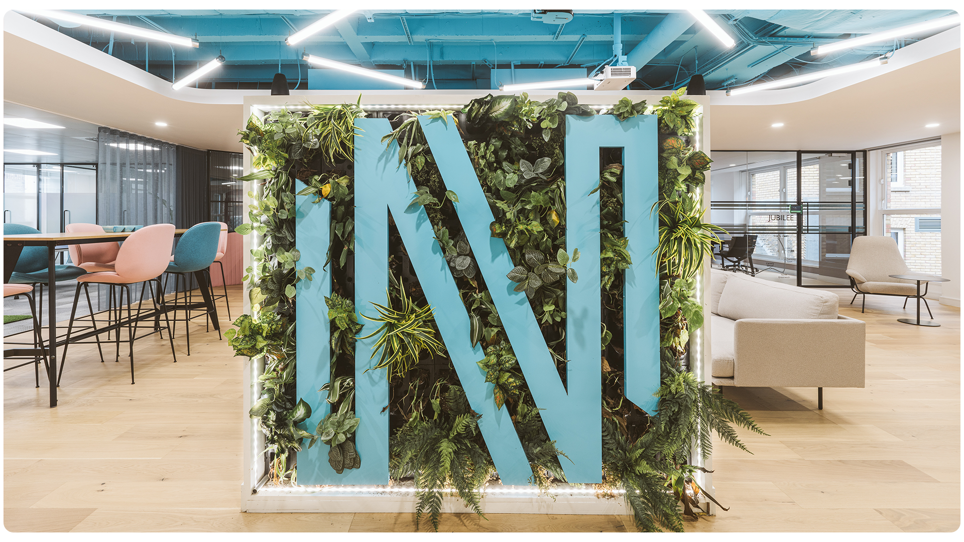 Bespoke branded green wall for Nium's London office