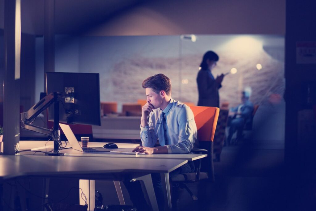 man working on computer in dark office